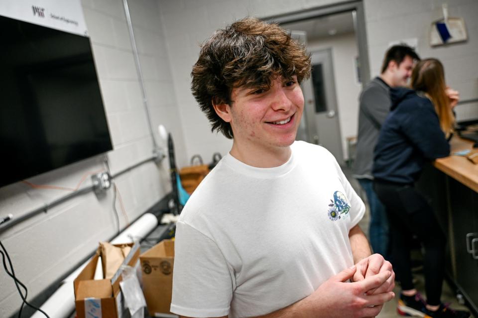 Junior Jason Gruber smiles while working in robotics class on Tuesday, Feb. 7, 2023, at Stockbridge High School. Gruber is working on a project to send a rocket 800 feet into the air with an egg that stays intact for the entire flight.