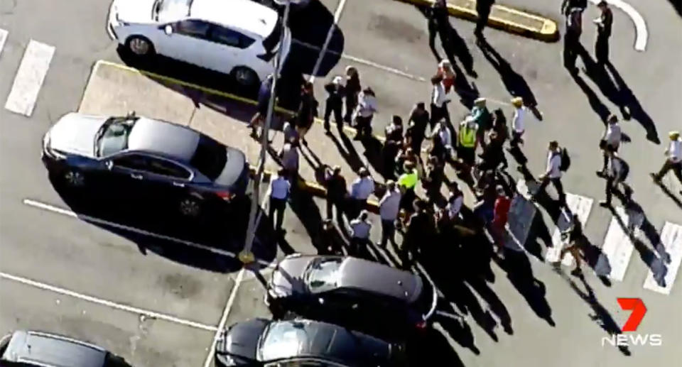 Brisbane shoppers gathered outside in shopping centre’s carpark after an evacuation. Source: 7 News