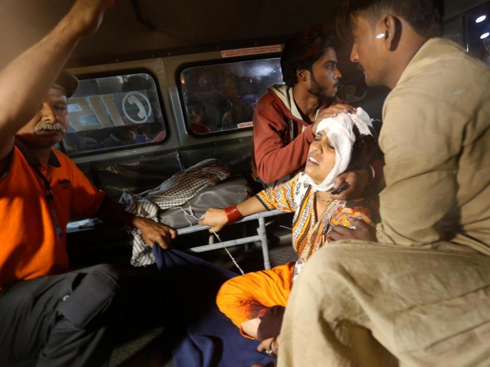 A woman arrives at a hospital in Karachi after an explosion at the Shah Noorani shrine in Balochistan (Akhtar Soomro/Reuters)