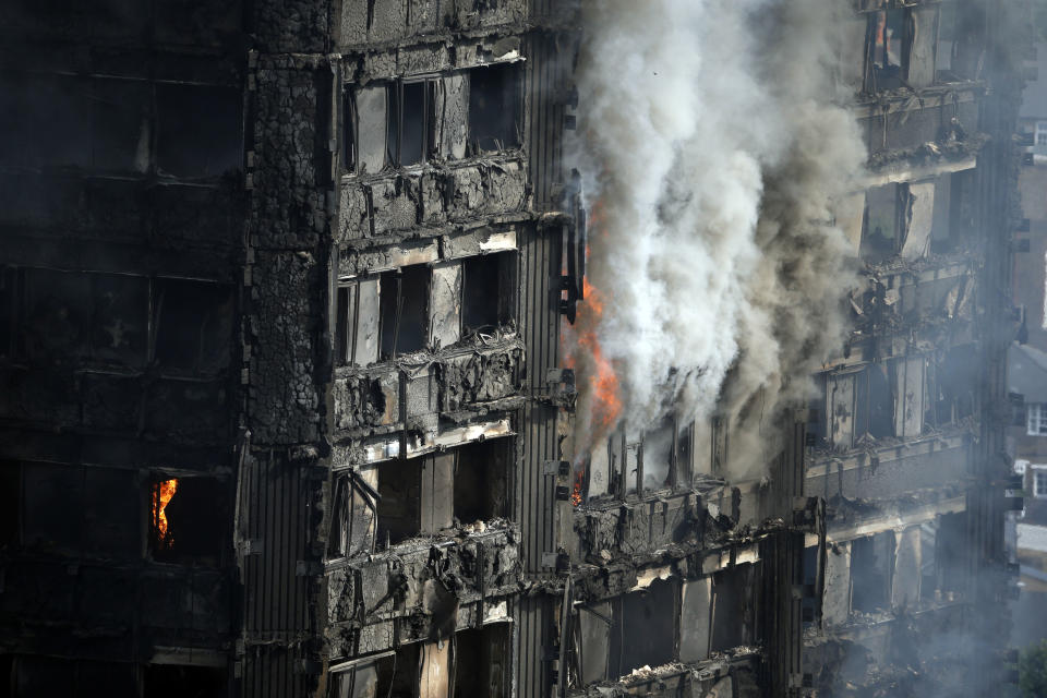 FILE - In this file photo dated Wednesday, June 14, 2017, The Grenfell Tower apartment block burns hours after a deadly blaze swept through the high rise apartment block in London. A report is due to be released Wednesday Oct. 30, 2019, following a far reaching inquiry into the deadly apartment block fire. (AP Photo/Alastair Grant, FILE)