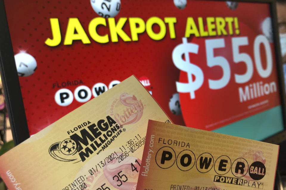 Powerball and Mega Millions lottery tickets are shown at a retailer, Wednesday, Jan. 13, 2021, in Surfside, Fla. Lottery players will have a shot Friday night at the fifth-largest jackpot in U.S. history after no tickets matched all the numbers in the latest Mega Millions drawing. The big prize for Powerball, the other national lottery game, is $550 million for Wednesday night's drawing. (AP Photo/Wilfredo Lee)