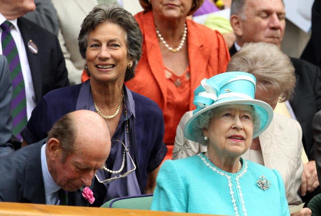 Virginia Wade sits behind the Queen in the Royal Box at Wimbledon in 2010