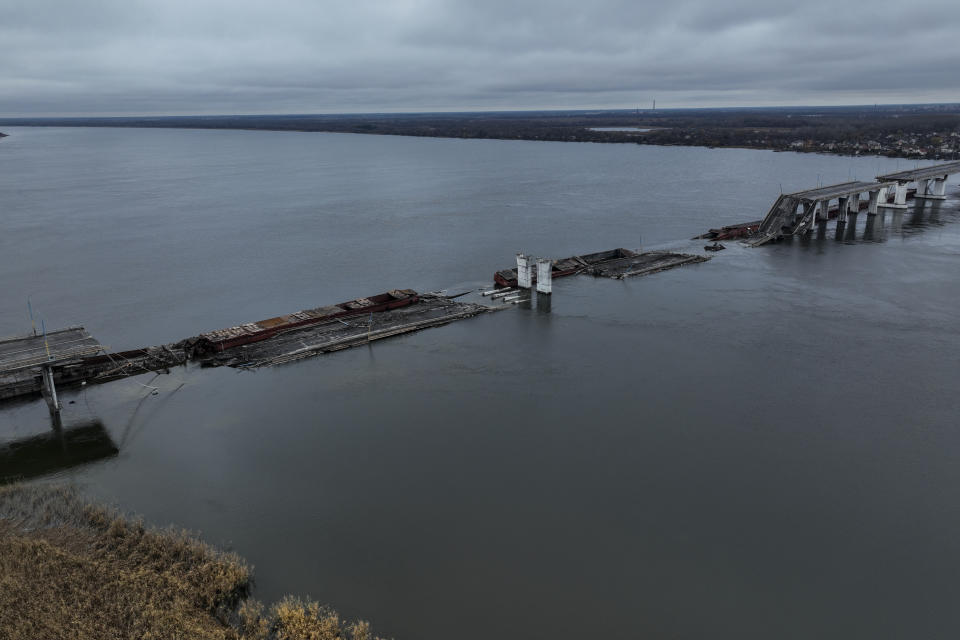 General view of the damaged Antonivsky Bridge in Kherson, Ukraine, Sunday, Nov. 27, 2022. The bridge, the main crossing point over the Dnipro river in Kherson, was destroyed by Russian troops in earlier November, after Kremlin's forces withdrew from the southern city. (AP Photo/Bernat Armangue)