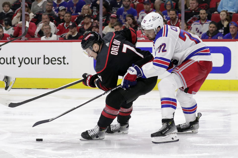 New York Rangers center Filip Chytil (72) defends against Carolina Hurricanes defenseman Dmitry Orlov (7) during the third period in Game 3 of an NHL hockey Stanley Cup second-round playoff series Thursday, May 9, 2024, in Raleigh, N.C. (AP Photo/Chris Seward)