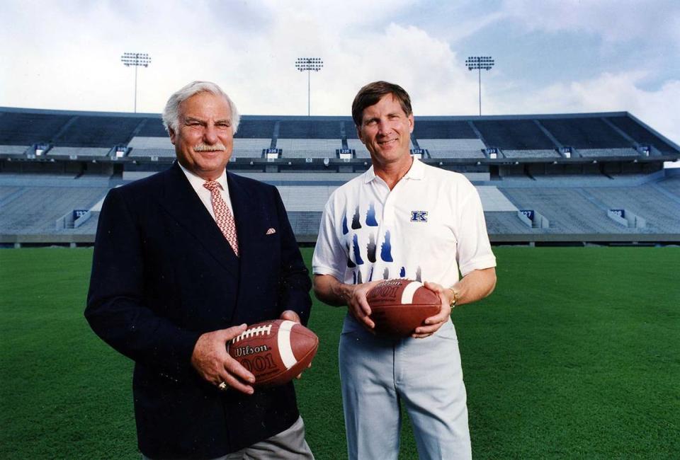 Then-University of Louisville football coach Howard Schnellenberger, left, and then-University of Kentucky football coach Bill Curry were photographed on June 25, 1993, after a news conference announcing the two schools had agreed to resume playing each other starting in 1994.