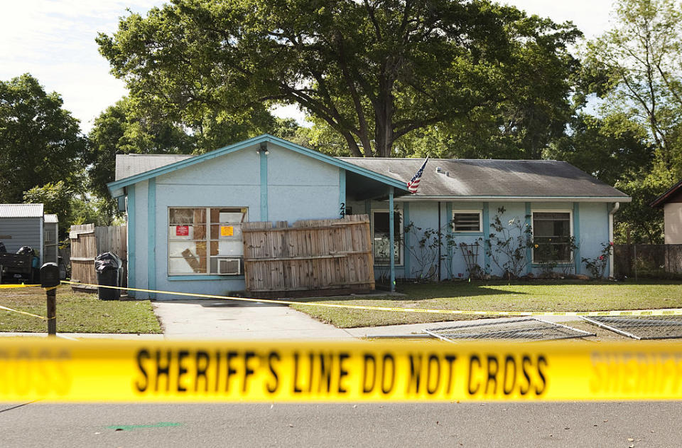 a house with sheriff's tape in front of it