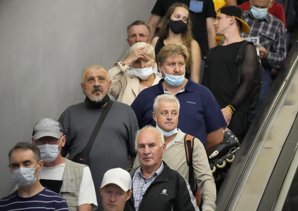 FILE - In this June 29, 2021, file photo, people ride the escalator in the subway amid the ongoing COVID-19 pandemic in St. Petersburg, Russia. Countries across Europe are scrambling to accelerate coronavirus vaccinations to outpace the spread of the delta variant in a high-stakes race to prevent hospital wards from filling up again with patients fighting for their lives. Daily new case numbers are already climbing sharply in countries like the United Kingdom, Portugal and Russia. (AP Photo/Dmitri Lovetsky, File)