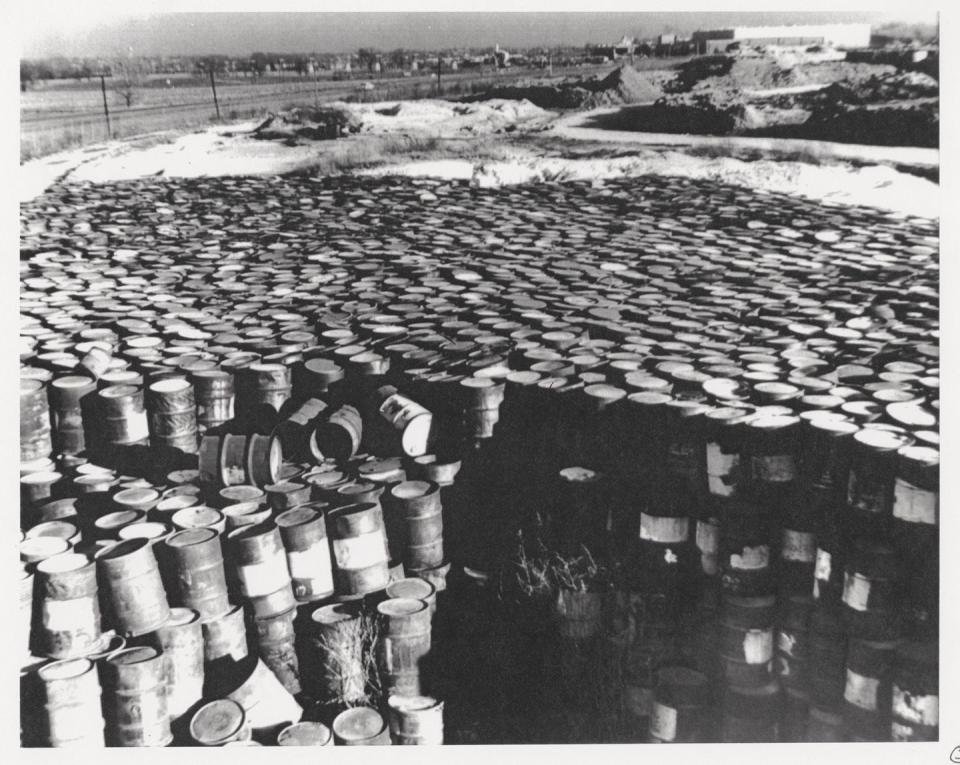 a black and white photo of a large pile of barrels