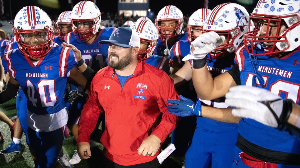 Washington Township's head football coach Mike Schatzman, center, is congratulated by his players after Washington Township defeated Atlantic City, 43-14, in the Central Jersey Group 5 football playoff game played at Washington Township High School on Friday, October 27, 2023.