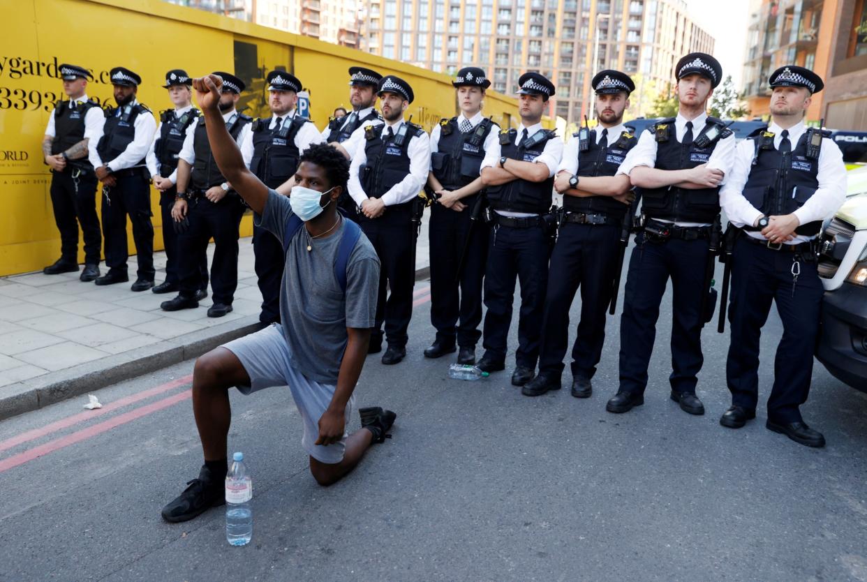 A protester takes the knee near the US embassy in London, during demonstrations against the death in Minneapolis police custody of African American George Floyd: Reuters