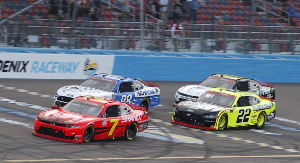 Justin Allgaier (7) leads Chase Briscoe (98), Austin Cindric (22) and Justin Haley (11) through Turn 4 during a NASCAR Xfinity Series auto race at Phoenix Raceway, Saturday, Nov. 7, 2020, in Avondale, Ariz. (AP Photo/Ralph Freso)