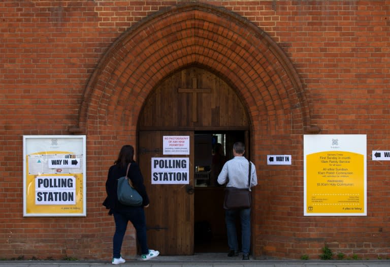 Voters arrive at a polling station in a church in south London on May 5, 2016, to cast their ballot papers