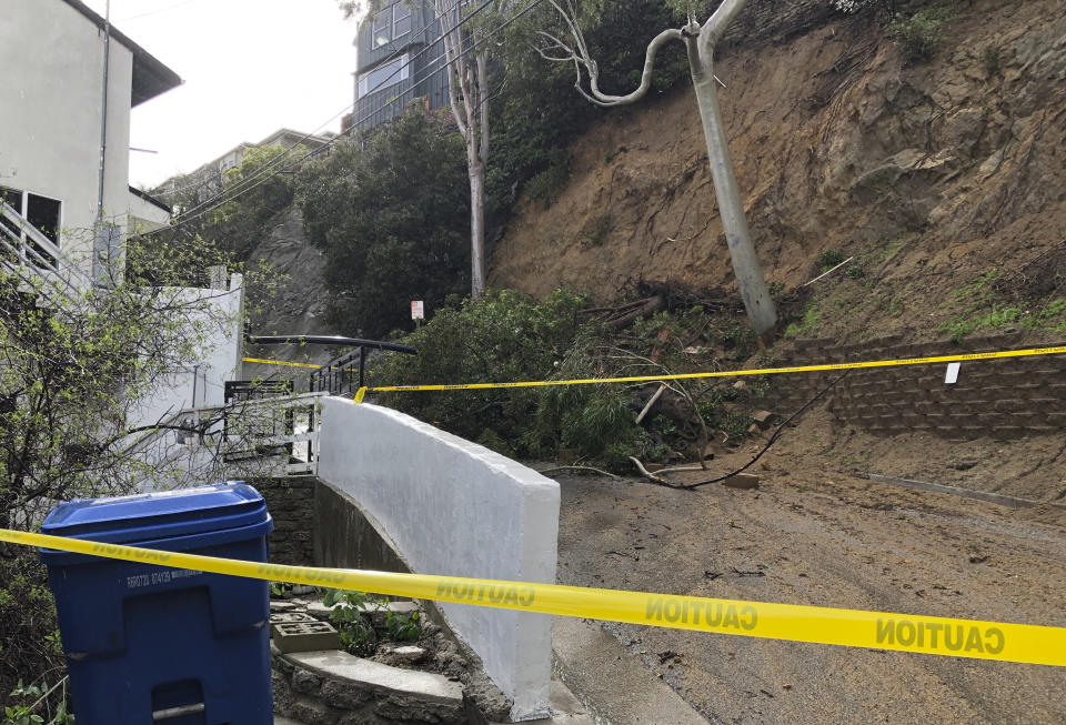 Debris from a mudslide blocks a street in the Laurel Canyon section of Los Angeles on Tuesday, Jan. 10, 2023. The latest in a relentless string of California storms is swamping roads, battering coastlines with high surf, turning rivers into gushing flood zones and forcing the evacuation of thousands in towns with histories of deadly mudslides. (AP Photo/Michael R. Blood)