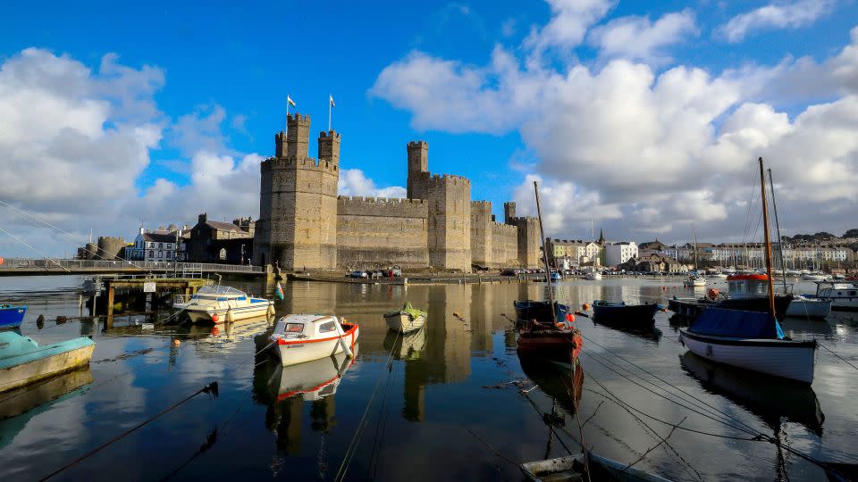 The dramatic Caernarfon Castle is a royal fortress-palace on the banks of the River Seiont in Wales.  - Peter Byrne/PA Images/Getty Images