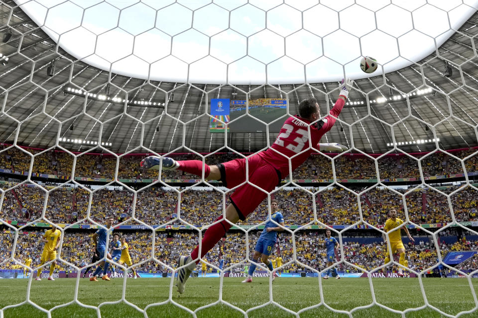 Romania's Nicolae Stanciu, fourth left, scores the opening goal during a Group E match between Romania and Ukraine at the Euro 2024 soccer tournament in Munich, Germany, Monday, June 17, 2024. (AP Photo/Matthias Schrader)