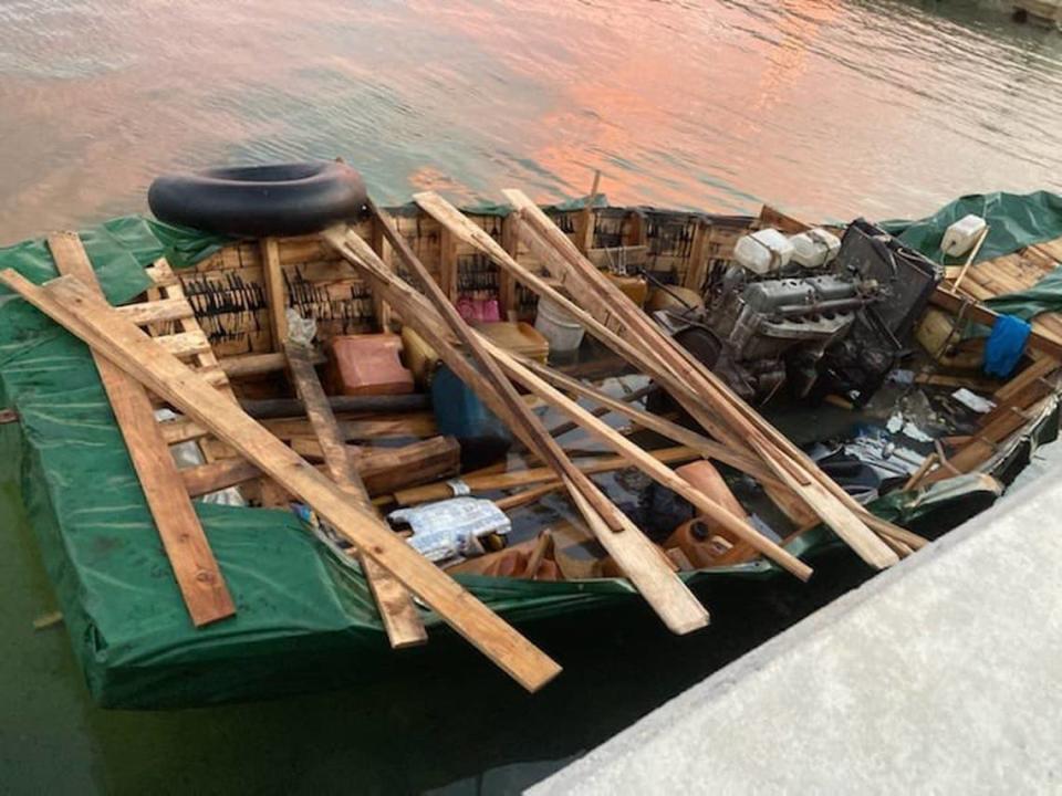 A migrant boat floats near a sea wall in Key West Wednesday, Aug. 3, 2022, that Border Patrol officials said carried 25 people from Cuba to the island chain.