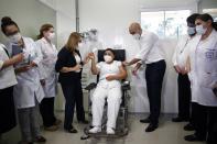 FILE - In this Feb. 22, 2021, file photo, nurse Mirian Arrua gets a shot of the Sputnik V vaccine for COVID-19, the first person to receive one in the nation, from Health Minister Julio Mazzoleni, right, at National Hospital in Itaugua, Paraguay. Just left of Arrua is Dr. Sonia Ozuna. Russia’s boast in August that it was the first country to authorize a coronavirus vaccine led to skepticism because of its insufficient testing on only a few dozen people. Now, with demand growing for the Sputnik V, experts are raising questions again, this time over whether Moscow can keep up with all the orders from countries that want it. (AP Photo/Jorge Saenz, File)