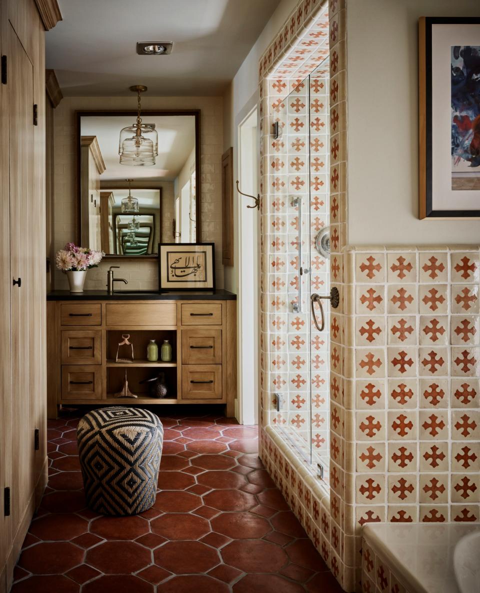 The main bathroom’s original tiles were preserved while the vanities at both ends of the space were replaced with more user-friendly contemporary designs.