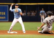 Jun 24, 2018; St. Petersburg, FL, USA;Tampa Bay Rays shortstop Willy Adames (1) forces out New York Yankees designated hitter Giancarlo Stanton (27) and throws the ball to first base for a double play during the tenth inning at Tropicana Field. Mandatory Credit: Kim Klement-USA TODAY Sports