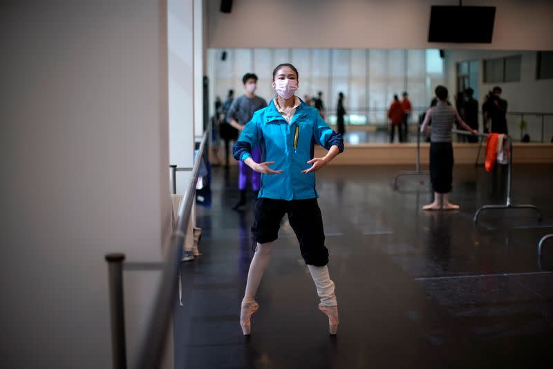 Shanghai Ballet dancers wearing masks practise in a dance studio in Shanghai