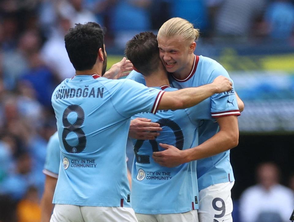 Erling Haaland, Bernardo Silva and Ilkay Gundogan celebrate after the win (Reuters)