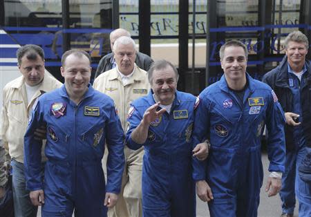 Russian cosmonauts Alexander Misurkin (L) and Pavel Vinogradov (C) and US astronaut Chris Cassidy (R) arrive a press conference at the airport in Karaganda, Kazakhstan, September 11, 2013. REUTERS/Maxim Shipenkov/Pool