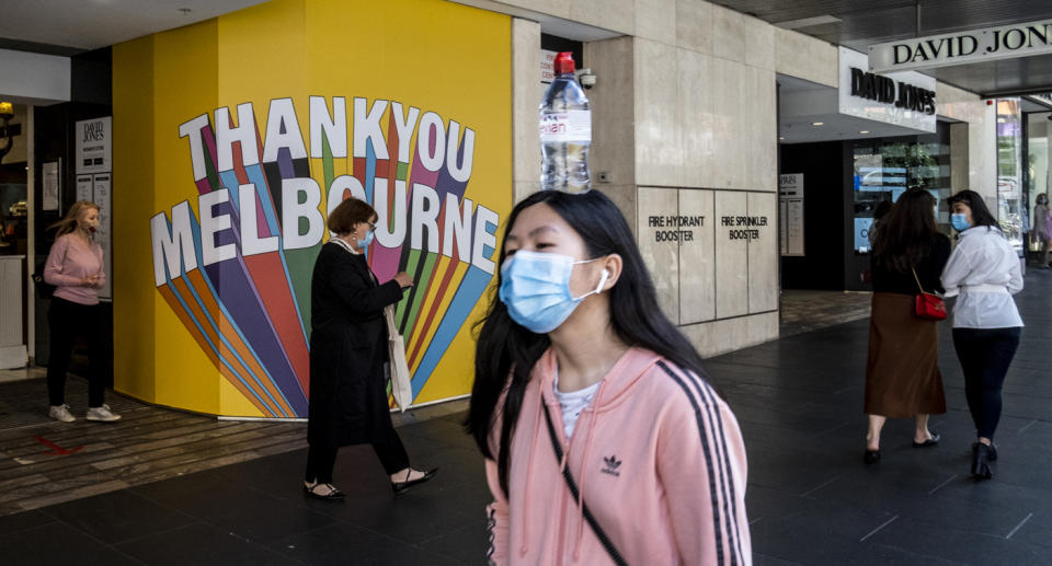 Melbourne streets with people wearing face masks.