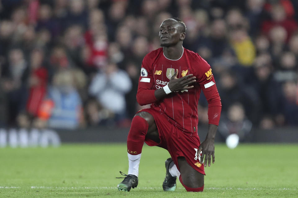 Liverpool's Sadio Mane celebrates after scoring the opening goal during the English Premier League soccer match between Liverpool and Wolverhampton Wanderers at Anfield Stadium, Liverpool, England, Sunday Dec. 29, 2019. (AP Photo/Jon Super)