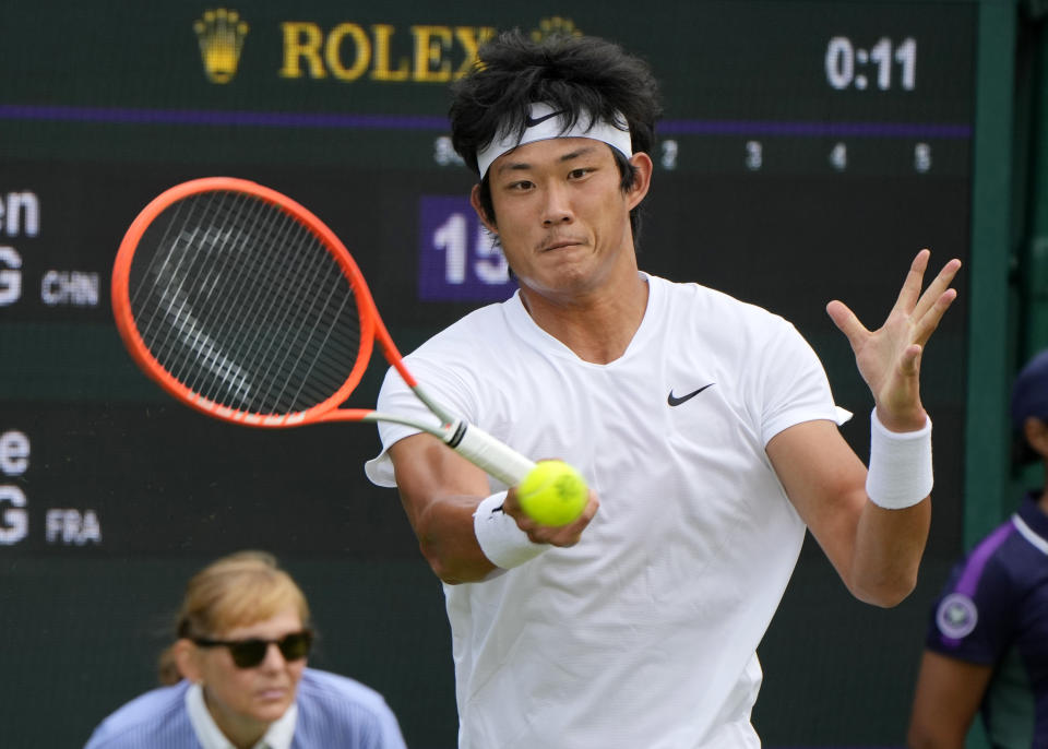 China's Zhizhen Zhang plays a return to Antoine Hoang of France during the men's singles first round match on day two of the Wimbledon Tennis Championships in London, Tuesday June 29, 2021. (AP Photo/Alastair Grant)