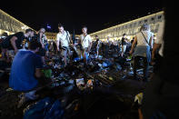 <p>Juventus supporters look for personal belongings at Piazza San Carlo after a panic movement in the fanzone where thousands of Juventus fans were watching the UEFA Champions League Final football match between Juventus and Real Madrid on a giant screen, on June 3, 2017 in Turin. (Massimo Pinca/AFP/Getty Images) </p>