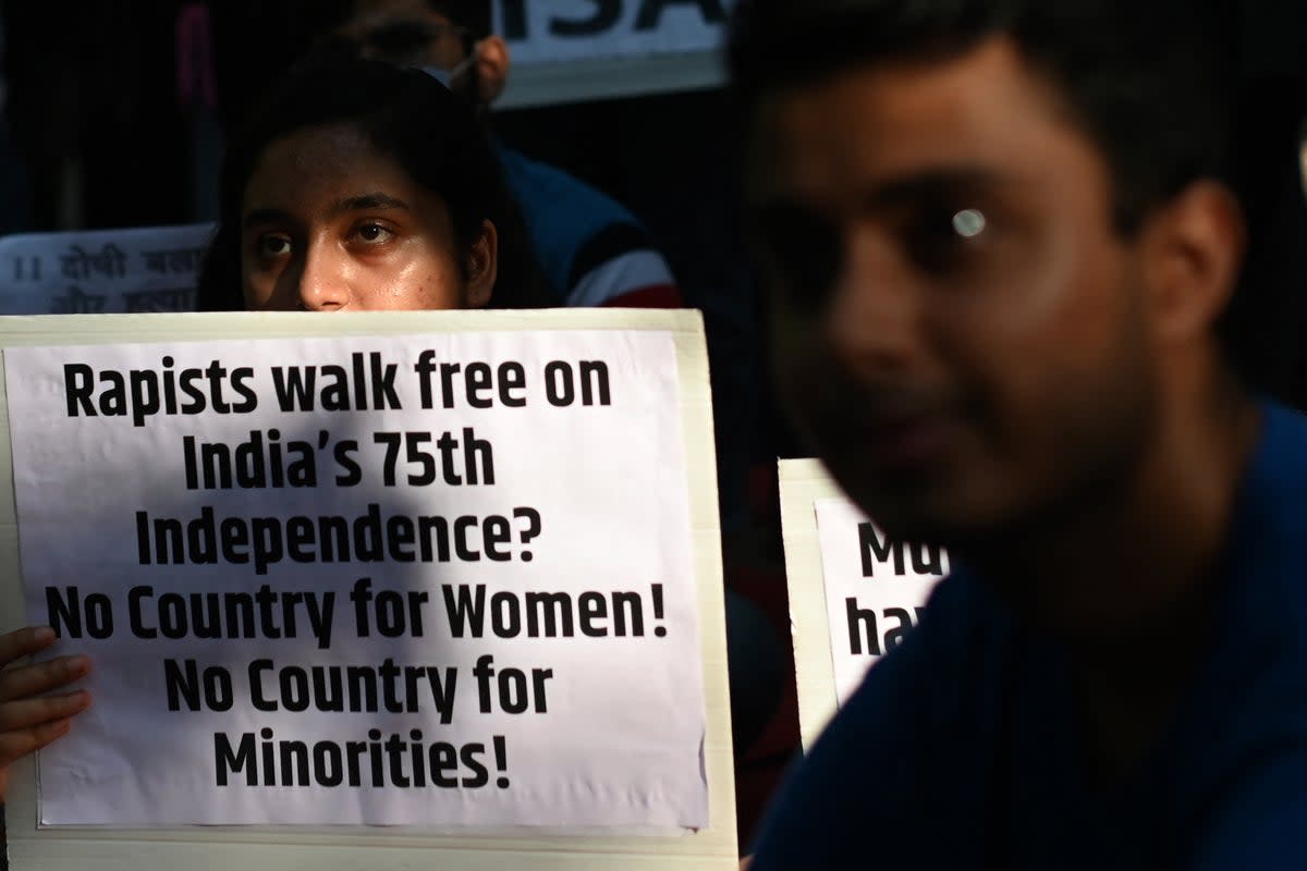 Demonstrators hold placards during a protest against the release of men convicted of gang-raping of Bilkis Bano during the 2002 communal riots in Gujarat, in  New Delhi on 27 August 2022 (AFP via Getty Images)