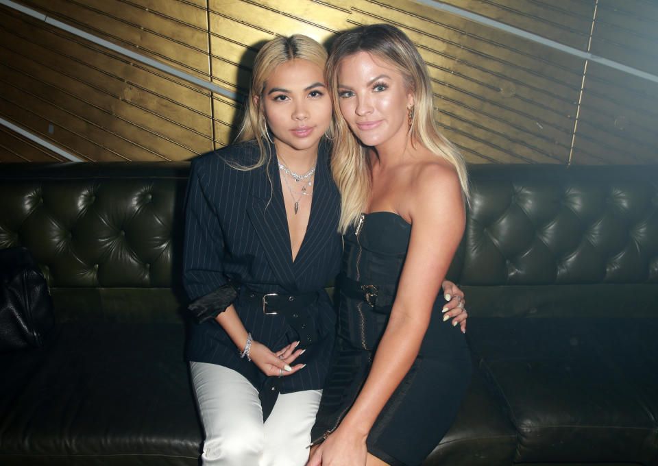 the couple sitting on a leather couch at an event