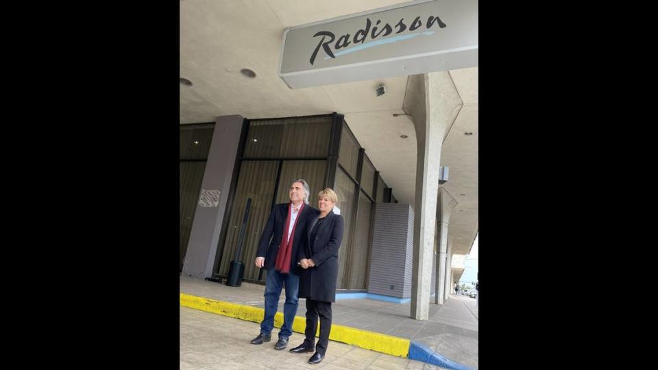 Sevak Khatchadourian, left, is joined by Fresno County Economic Development Corp. president and CEO Lee Ann Eager at an event announcing the sale of the former Radisson Hotel in downtown Fresno to a partnership led by Khatchadourian.