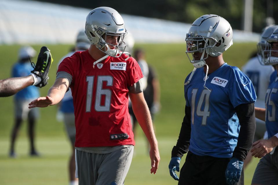 Detroit Lions quarterback Jared Goff talks to wide receiver Amon-Ra St. Brown during training camp at Detroit Lions Headquarters and Training Facility in Allen Park on Monday, July 24, 2023.