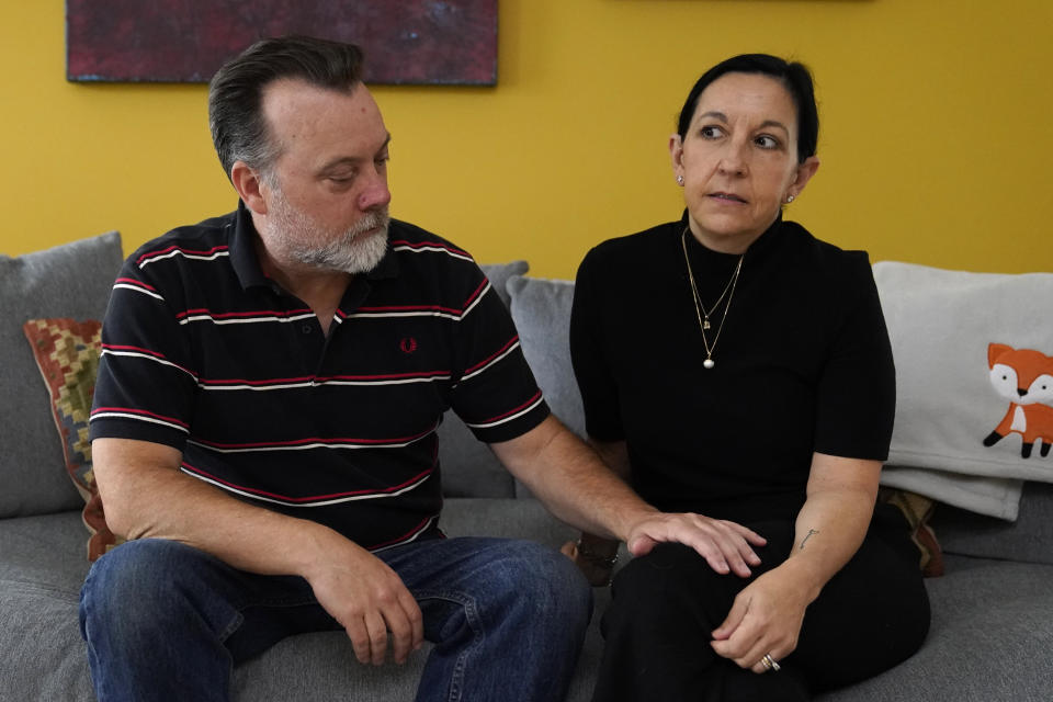 Matt Lemp, left, and his wife Mercedes Lemp pose for The Associated Press in their home, Friday, Oct. 16, 2020, in Frederick, Md. The Lemp's are dealing with the death of their son, Duncan Lemp, who was shot at their home in Potomac, Md., during a no-knock police raid on March 12, 2020. Lemp's family have said through their attorney that, based on an eyewitness, they believe Lemp was shot without warning while he was asleep. (AP Photo/Julio Cortez)