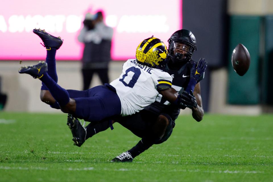 Michigan defensive back Mike Sainristil breaks up a pass intended for Michigan State wide receiver Tre Mosley during the first half Saturday, Oct. 21, 2023, in East Lansing.