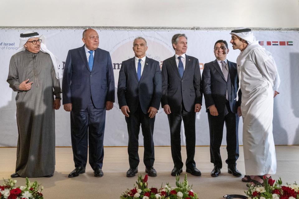 After meeting for the Negev Summit, Bahrain's Foreign Minister Abdullatif bin Rashid al-Zayani, left, Egypt's Foreign Minister Sameh Shoukry, Israel's Foreign Minister Yair Lapid, U.S. Secretary of State Antony Blinken, Morocco's Foreign Minister Nasser Bourita, and United Arab Emirates' Foreign Minister Sheikh Abdullah bin Zayed Al Nahyan, talk while posing for a photograph Monday, March 28, 2022, in Sde Boker, Israel. (AP Photo/Jacquelyn Martin, Pool)