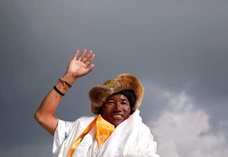 FILE PHOTO: Kami Rita Sherpa, 48, a Nepali mountaineer waves towards the media personnel upon his arrival after climbing Mount Everest for a 22nd time, creating a new record for the most summits of the worldÕs highest mountain, in Kathmandu, Nepal May 20, 2018. REUTERS/Navesh Chitrakar/File Photo