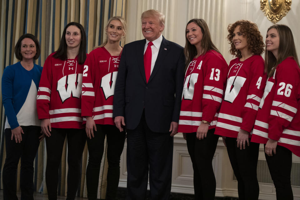 President Donald Trump poses for photos with members of the University of Wisconsin-Madison Women's Hockey Team during the NCAA Collegiate National Champions Day at the White House, Friday, Nov. 22, 2019, in Washington. (AP Photo/ Evan Vucci)