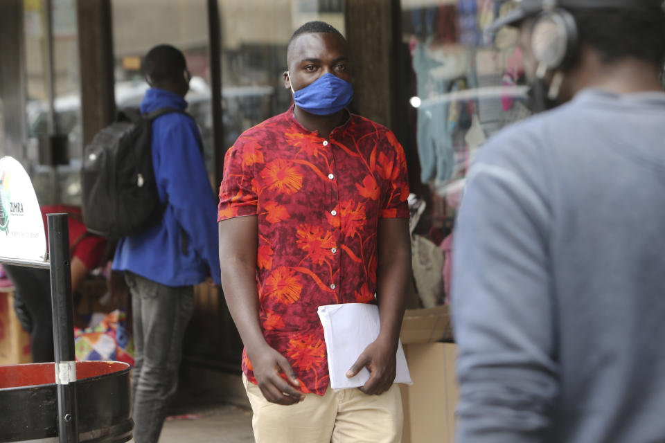 Emmanuel Reyai walks on the streets of Harare while looking for a job, Wednesday, Aug, 5, 2020. Around the world, young people armed with new degrees, diplomas and professional qualifications are struggling to enter the workforce as the pandemic pushes the global economy into recession. Two years after graduating with from Zimbabwe’s Midlands State University, 24-year old Emmanuel Reyai is no closer to his goal of getting a job related to his degree in local governance. His search is stymied by both the African country’s economic collapse and the coronavirus outbreak. (AP Photo/Tsvangirayi Mukwazhi)