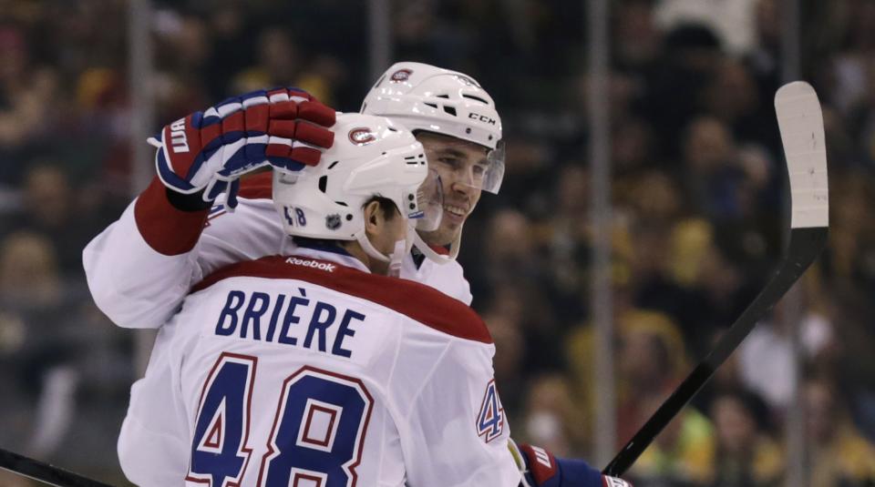 Montreal Canadiens defenseman Alexei Emelin, rear, is congratulated by teammate Daniel Briere after his goal during the first period of an NHL hockey game, Monday, March 24, 2014, in Boston. (AP Photo/Charles Krupa)