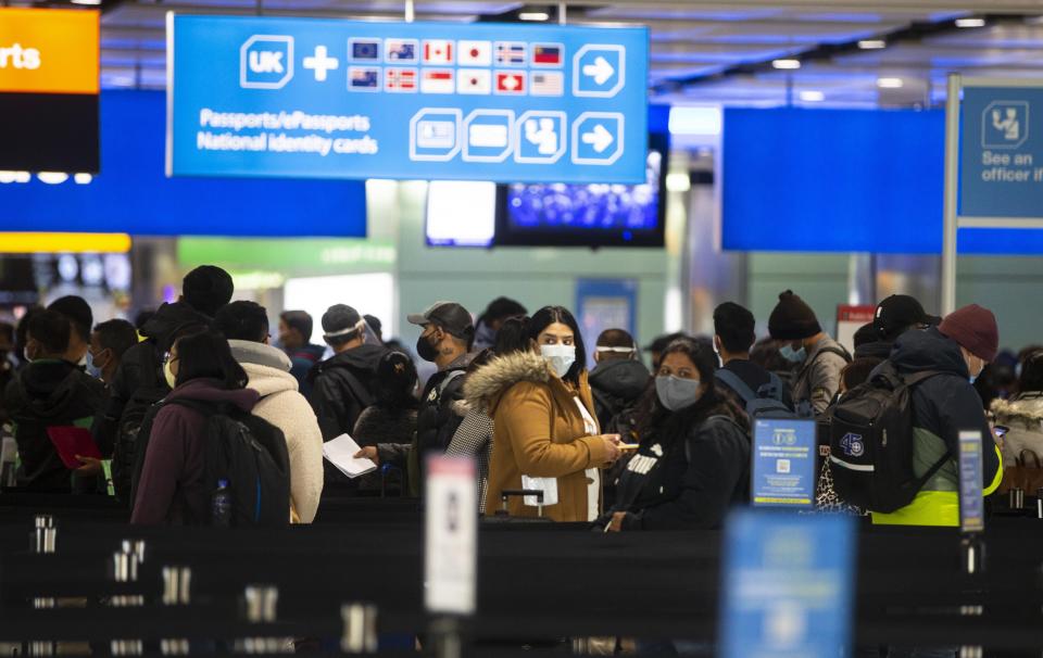 Passengers queue at Heathrow (PA Wire)