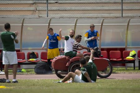 New York Cosmos player Adam Moffat (C) signals to teammates as he rides on a motorcycle sidecar after a training session ahead of his exhibition match against Cuba's national team on Tuesday, in Havana June 1, 2015. REUTERS/Alexandre Meneghini