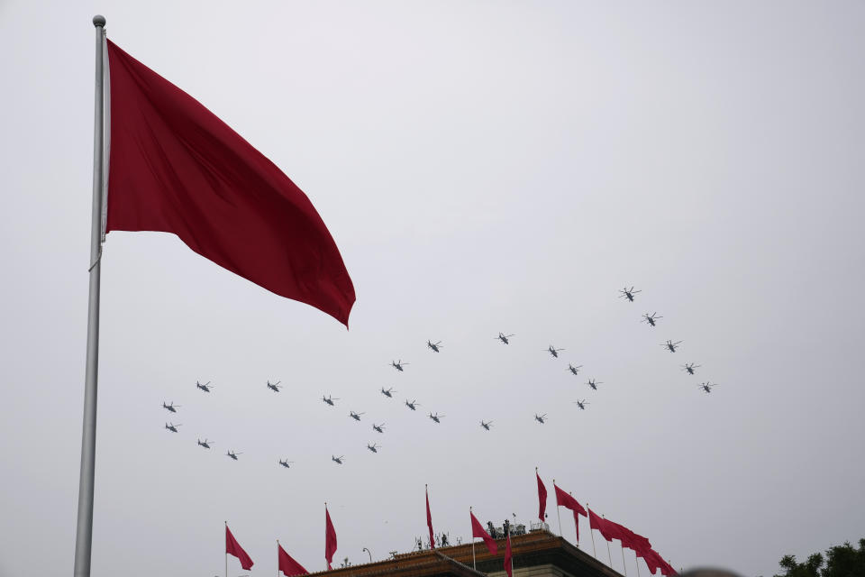 Helicopters fly over Chinese flags at Tiananmen Square in the formation of "100" during a ceremony to mark the 100th anniversary of the founding of the ruling Chinese Communist Party at Tiananmen Gate in Beijing Thursday, July 1, 2021. (AP Photo/Ng Han Guan)