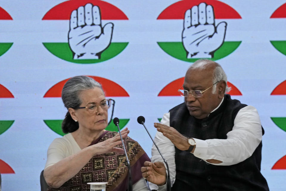 Congress party president Mallikarjun Kharge, right, adjusts the microphones for senior party leader Sonia Gandhi to speak during a press conference at their party headquarters in New Delhi, India, Thursday, March 21, 2024. (AP Photo/Manish Swarup)