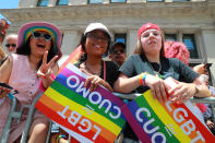 <p>A young woman flashes peace sign as parade watchers hold LGBT signs during the N.Y.C. Pride Parade in New York on June 25, 2017. (Photo: Gordon Donovan/Yahoo News) </p>