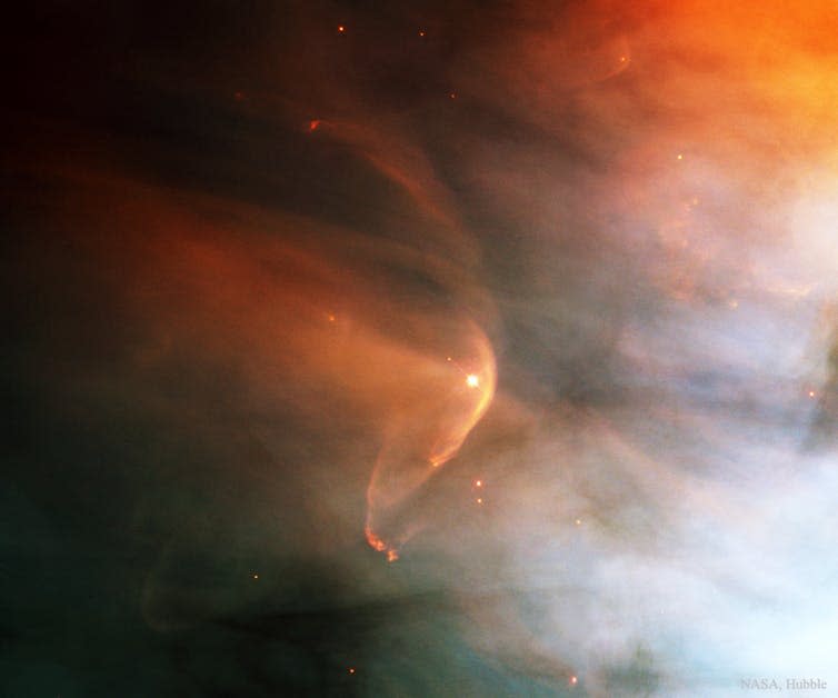 Hubble Space Telescope image of a star travelling through the Orion nebula creating a 'wake' of gas around it’s heliosphere.