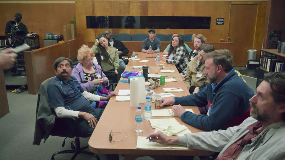 jurors sitting at a long conference table together