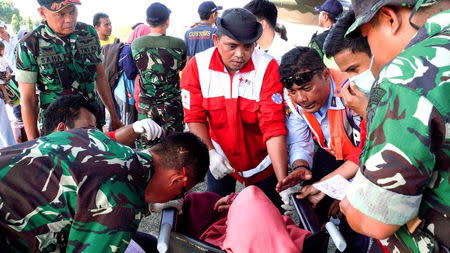 Ambulance and evacuation services are provided by Indonesia Red Cross for affected people at Sultan Hasanuddin Airport, Makassar, Indonesia September 30, 2018 in this picture obtained from social media. Picture taken September 30, 2018. PALANG MERAH INDONESIA/via REUTERS