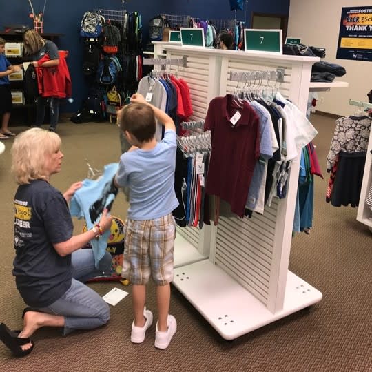 New beginnings are even more exciting with the perfect backpack. Foster children dive into the selection at Citizens Caring for Children's Resource Center, ready for a fresh school year.